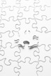 White jigsaw puzzle with one piece floating above