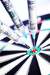 Syringes with 100 dollars inside, stuck in a dartboard