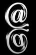 At symbol paperweight on reflective surface