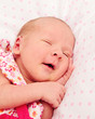 Adorable sleeping newborn baby girl