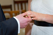 Detaily fotografie Wedding ceremony with ring going on bride finger