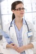 Portrait of young doctor with clipboard