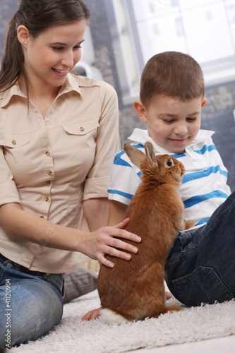Photo: Mother and son with cute pet bunny Mother and son with cute pet bunny