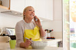 Retired woman preparing food at home