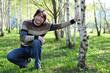 Middle-aged man in a birch grove