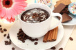 cup of coffee and gerbera, beans, cinnamon sticks cup of coffee and gerbera, beans, cinnamon sticks
