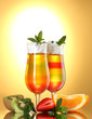 fruit jelly in glasses and fruits on yellow background fruit jelly in glasses and fruits on yellow background