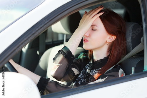 Photo: Troubles on the road, Girl hides face in hands while in a car Troubles on the road, Girl hides face in hands while in a car