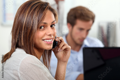 Photo: Couple at home with laptop and cellphone Couple at home with laptop and cellphone