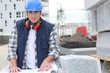 construction worker looking at his plans