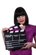 Young woman with clap of cinema Young woman with clap of cinema