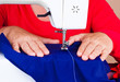 Hands working on a sewing machine Hands working on a sewing machine