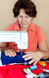 Hispanic woman working on a sewing machine Hispanic woman working on a sewing machine