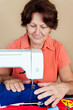 Hispanic woman working on a sewing machine Hispanic woman working on a sewing machine