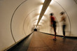 Joggers running through a tunnel