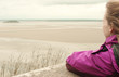 young woman looking to a distant island