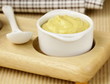 French mustard sauce in white gravy boat