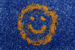 smiling golden face of sand  on  blue background