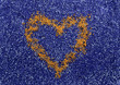 Golden heart symbol on the blue sand