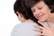 A mother hugging her daughter.