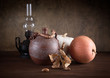 Still-life with a jug an oil lamp and pumpkins