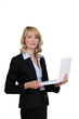 canvas print picture - Businesswoman standing with her laptop.