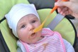 Adult feeding baby
