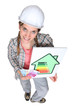 Tradeswoman holding an energy efficiency rating sign
