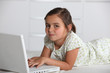 Girl lying with computer