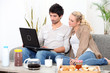 Couple using a laptop computer at breakfast