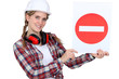 Traffic guard holding a no entry sign