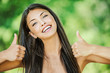 woman with bare shoulders happily raises his thumb up
