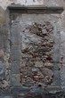 Photo: Old window in gray stone wall blocked by bricks and stones Old window in gray stone wall blocked by bricks and stones