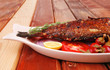 main course: whole fryed sunfish on wood