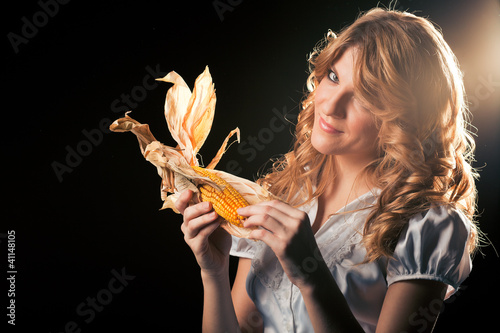 Photo: Blond girl with corncob Blond girl with corncob
