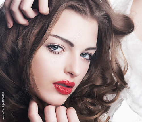 Photo: Closeup beautiful brunette woman face with sexy red lips Closeup beautiful brunette woman face with sexy red lips