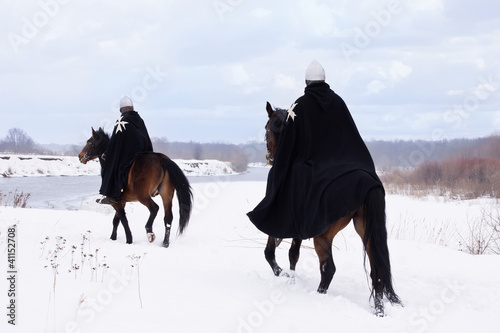 Photo: Medieval knights of St. John (Hospitallers) riding on a horses Medieval knights of St. John (Hospitallers) riding on a horses