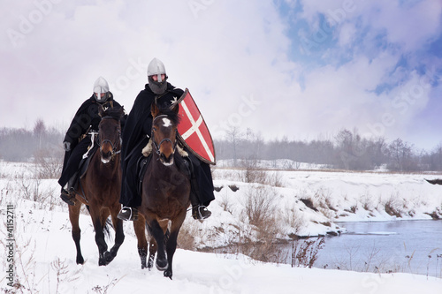 Photo: Medieval knights of St. John (Hospitallers) riding on a horses Medieval knights of St. John (Hospitallers) riding on a horses