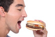 man eating hamburger