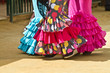 Women wearing flamenco dresses at Seville's fairground.