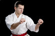Contrast karate young fighter on black