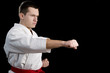 Contrast karate young fighter on black