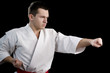 Contrast karate young fighter on black