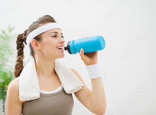 Photo: Fitness woman drinking water Fitness woman drinking water