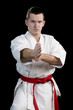 Contrast karate young fighter on black