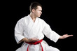 Contrast karate young fighter on black