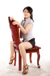 Beautiful girl in the studio sits on a chair