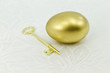 Gold egg with key on white damask Gold egg with key on white damask