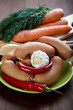 Sausages with spices and vegetables on an old table Sausages with spices and vegetables on an old table