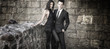 Conceptual portrait of a young couple in elegant evening dresses